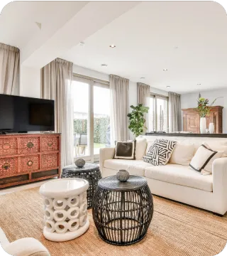 Bright, modern living room with beige sofas, large windows, and natural lighting, representing the comfort and professionalism of A.C.F. Home Inspections serving Dundee and Polk County, FL.