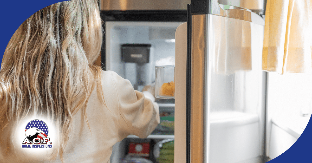 A.C.F. Home Inspections FL Woman reaching into an open refrigerator in a kitchen.
