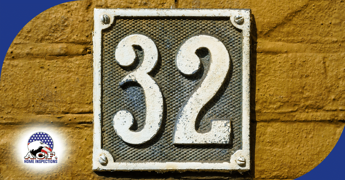 A.C.F. Home Inspections FL White house number 32 on a square metal plaque attached to a wall